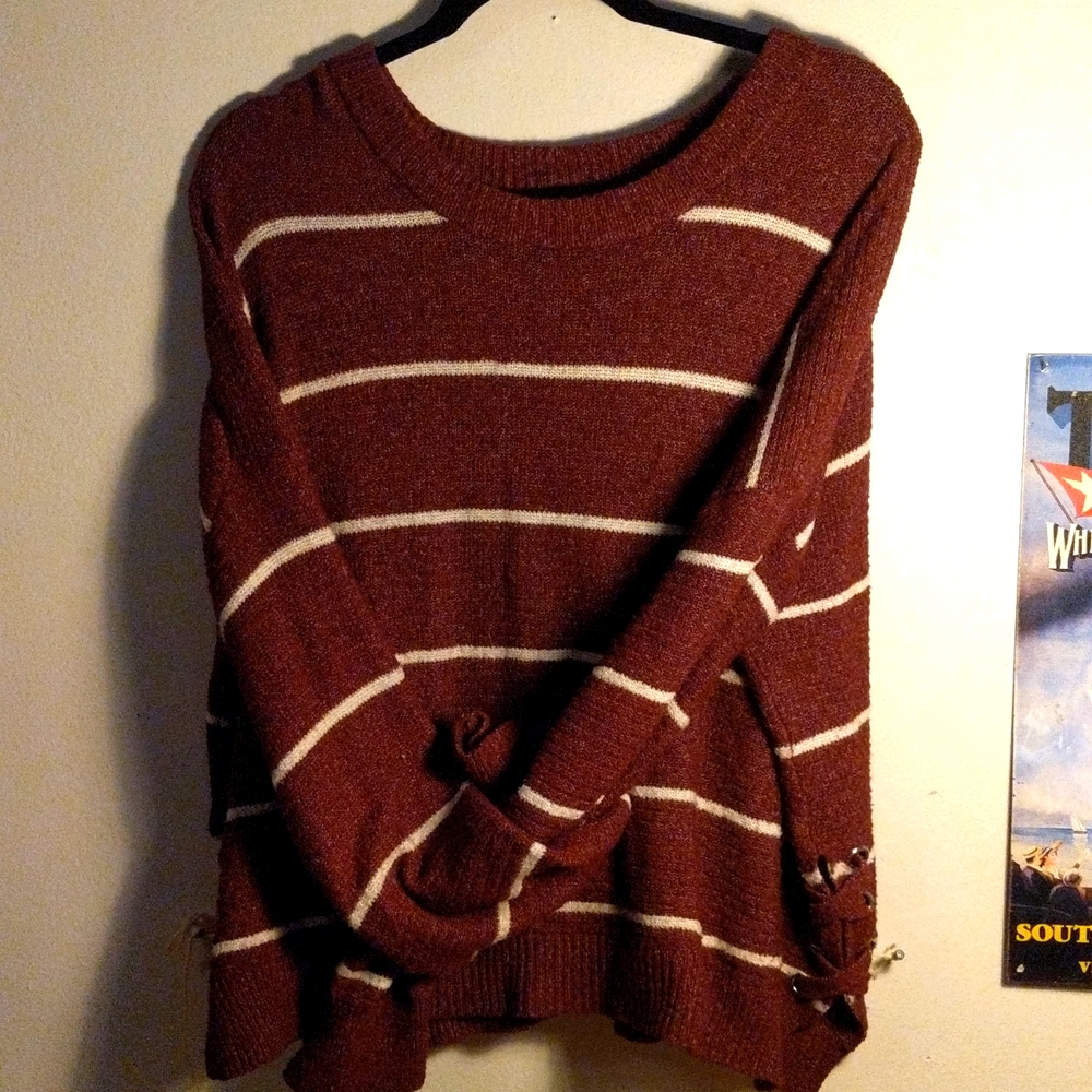 Sweater with grommets